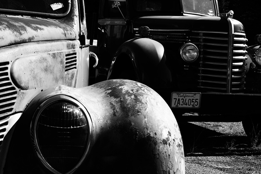 Black and White photo of two old abandon trucks from the 40's. Photo taken by Austin Metzger